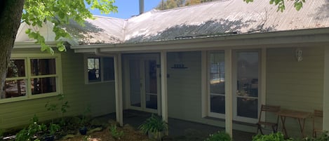 Charming country cottage, with shady golden elm tree and flourishing garden.
