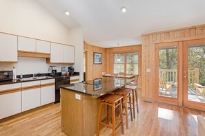 Kitchen looking toward dining and back porch.