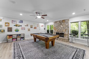 Lower living area with pool table. Fireplace not operational.