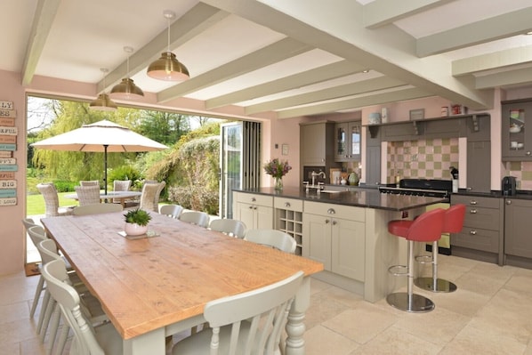 Large country style Kitchen with dining table to comfortably seat ten people. 