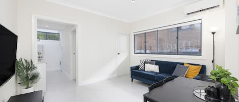 LIVING AREA: Blue Velvet comfortable sofa, wall mounted 55inch Smart TV