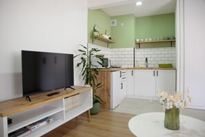 Kitchen with an induction stove, electric kettle and a microwave