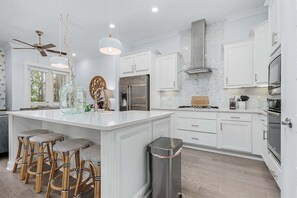 Gorgeous kitchen stocked with many amenities.