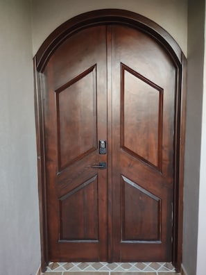Come on in! Our large front doorway features coded door entry and french door.