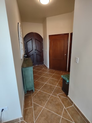 Ground floor Entryway w/laundry & hall bathroom on right and common area behind.