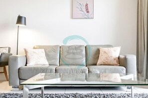 Zen Ocean Meadows- Cozy 2-BR/2-BA Sea View Retreat - "Discover the joy of cozy evenings in our warm and inviting living room, where laughter fills the air