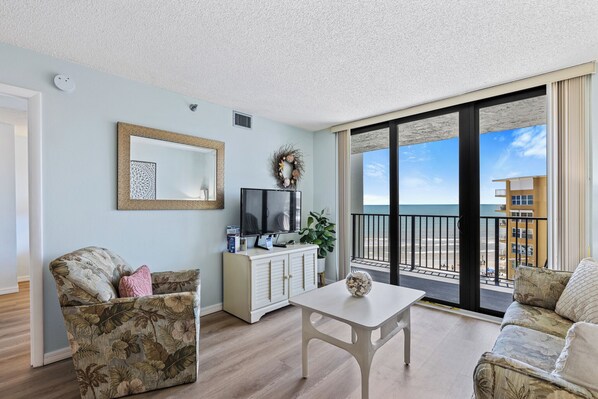 This charming 1-bedroom, 1-bath corner unit, adorned with delightful beach decor, offers a cozy and inviting atmosphere.