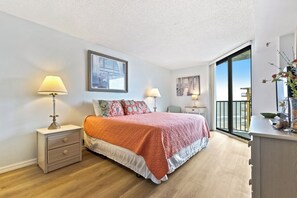 Ocean view bedroom with king-sized bed and sliders to the balcony.