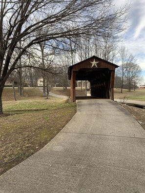 This photo shows the covered bridge!  Please drive through!! 