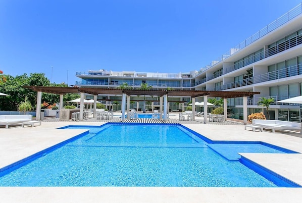 Take a refreshing dip in the resort-style pool surrounded by lush greenery.