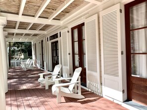 ADIRONDACK SEATING FOR FIVE ON OPEN AIR PORCH AT ENTRANCE