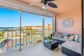 Balcony sectional with sunset, pool deck, tennis & pickle ball views. 