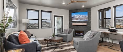 Living Room: "Cozy setup with fireplace, TV, and scenic views from the windows."