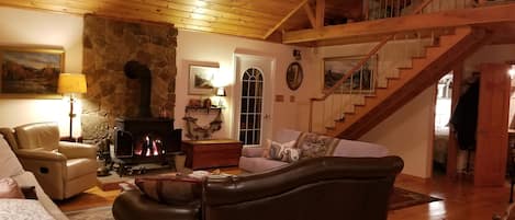 Great room with woodstove and cathedral ceilings