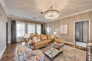 A bright, open living room with a leather sectional and chaise sofa, offering a perfect blend of comfort and elegance for ultimate relaxation.