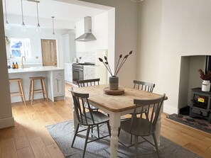 As well as a breakfast bar area, the open plan kitchen diner has a dining table.