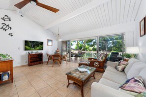 Bright and spacious living area with Palliser queen sofa sleeper and upper lanai