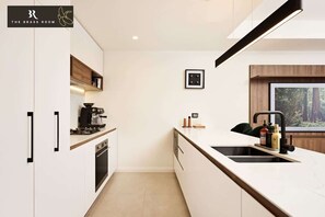 Our sleek kitchen features modern appliances and a spacious layout, perfect for cooking and entertaining.