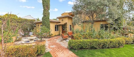 Full fenced garden with fruit trees and stone fountain, sunset views
