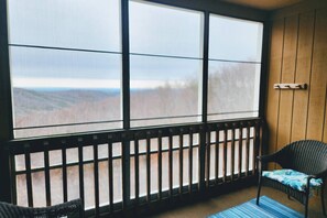 The screened-in porch offers beautiful mountain views and can be accessed from the main bedroom