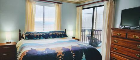 The main bedroom offers a King size bed with end tables, chest of drawers, TV and its own access to the balcony