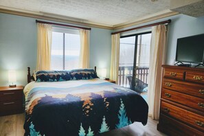The main bedroom offers a King size bed with end tables, chest of drawers, TV and its own access to the balcony