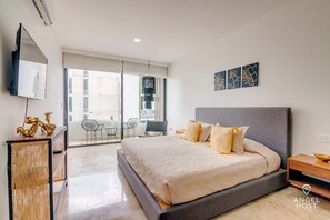 A wall-mounted flatscreen Smart TV with streaming services and a comfy king bed fit for royalty