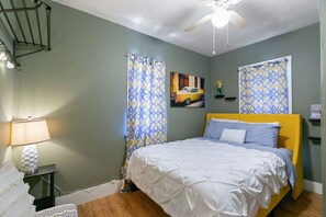 Cozy bedroom with a plush bed and a ceiling fan to keep the air flowing!