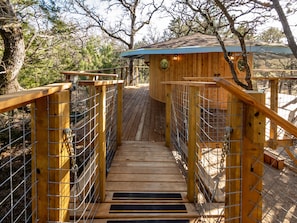 Chain bridge connecting stairs to treehouse deck