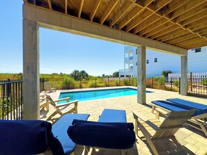 Relax by the heated pool, just steps from the sandy shores of the Cape
