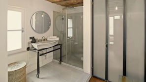 This roomy ensuite includes a large built-in wardrobe behind the three glass doors. Plenty of space for everything.