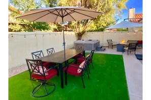 Your private outdoor dining by the fire pit and putting green.