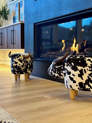 Cow ottomans cozy by the fire. Moo!