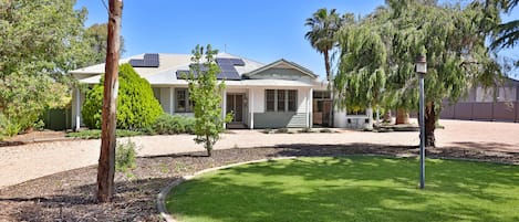 Plenty of shady parking, including large area on the right of the house