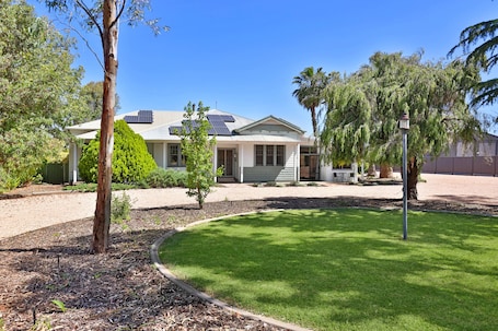 Plenty of shady parking, including large area on the right of the house
