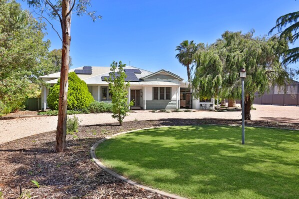 Plenty of shady parking, including large area on the right of the house