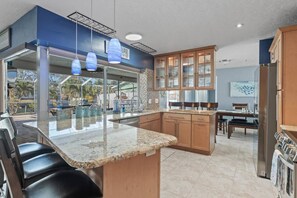 The kitchen centers the home providing sweeping water views and sunshine with seating for six at the bar areas!