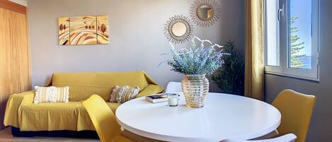 Charming Porto Moniz home adorned in lovely yellow tones. #cozy #sideoceanview #sofa #livingroom