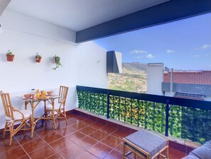 Relaxing balcony with a comfortable seating area, perfect for enjoying outdoor meals #balcony #mountainview #breakfast #dinner