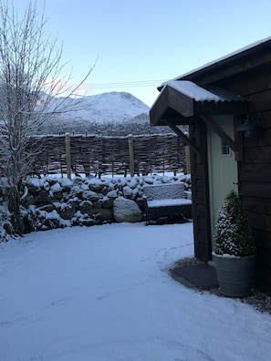 Caban in snow and view towards Cader Idris
