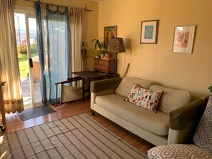 Back sun room with fan and cable tv.