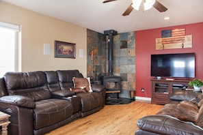 Living room with wood stove and flat screen television