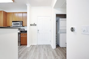 Entry and Washer & Dryer inside the unit next to entry