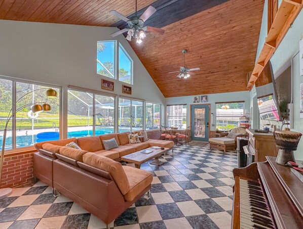 Large gathering family room with view of pool