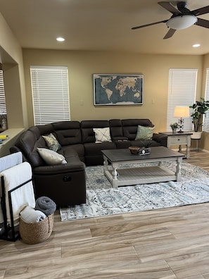 Family room with large sectional with recliners on each end