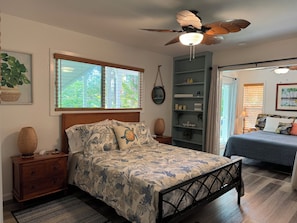 Primary bedroom adjoins a bright sitting area with additional queen size bed.