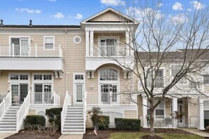 Living room opens to a deck in the front and primary bedroom has balcony