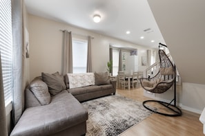 Unwind in the cozy living room adorned with unique artwork and let the stress of everyday life melt away