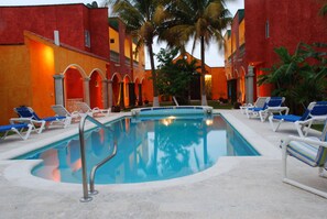 Sunset photo of the 4 villas and the oversized pool.