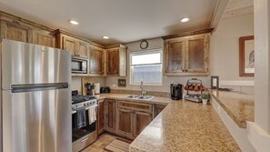 Kitchen with gas stove and cook top, fully stocked with dishes and cooking utensils, dish wash, fridge,  Keurig coffee maker, tea pot, and more! 